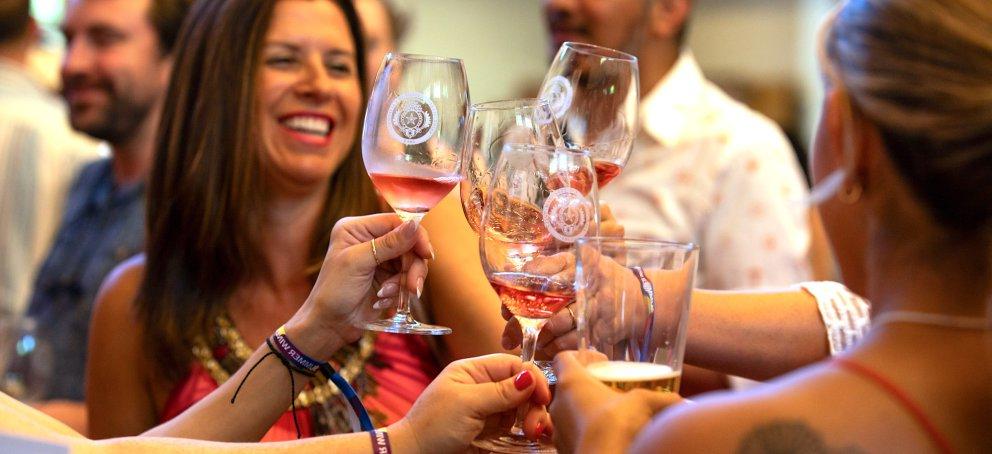 Five people cheersing wine glasses